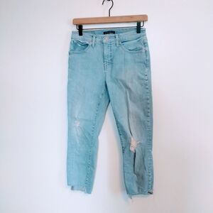 Lucky Brand light wash mid rise crop jeans size 6. Distressed knee and raw hem.
